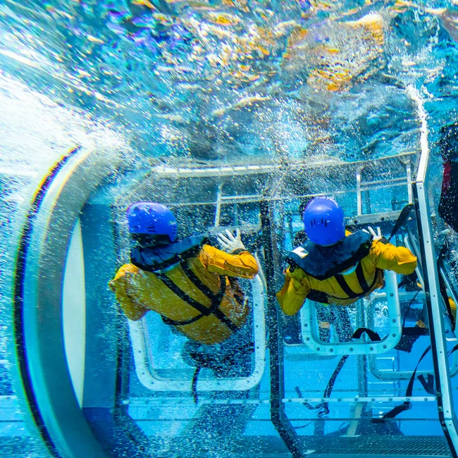A helicopter model being submerged in a pool for real life training