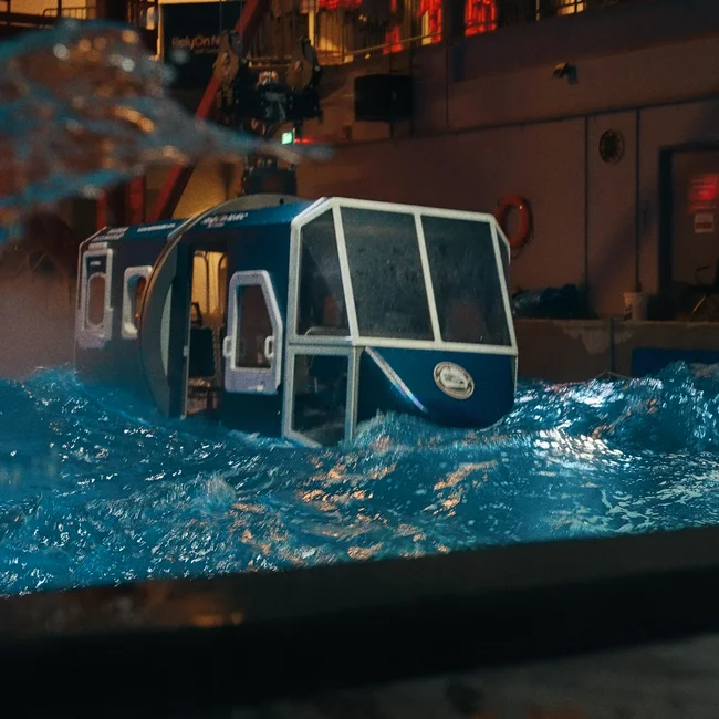 A helicopter model being submerged in a pool for real life training