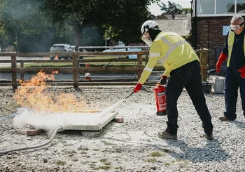 Course delegate extinguishes fire hazard on training site during incident management training