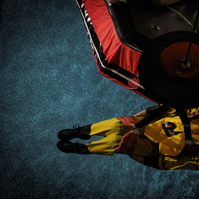 Trainee being lifted from pool as part of training