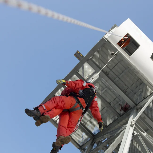 INDUSTRY - RENEWABLES - Person being lowered from wind turbine