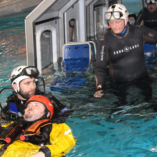 BOSIET training where the trainee saves a person in the pool emulating the sea