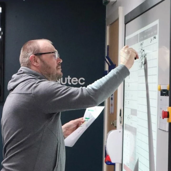 Instructor writing on white board a plan as part of the crisis management training