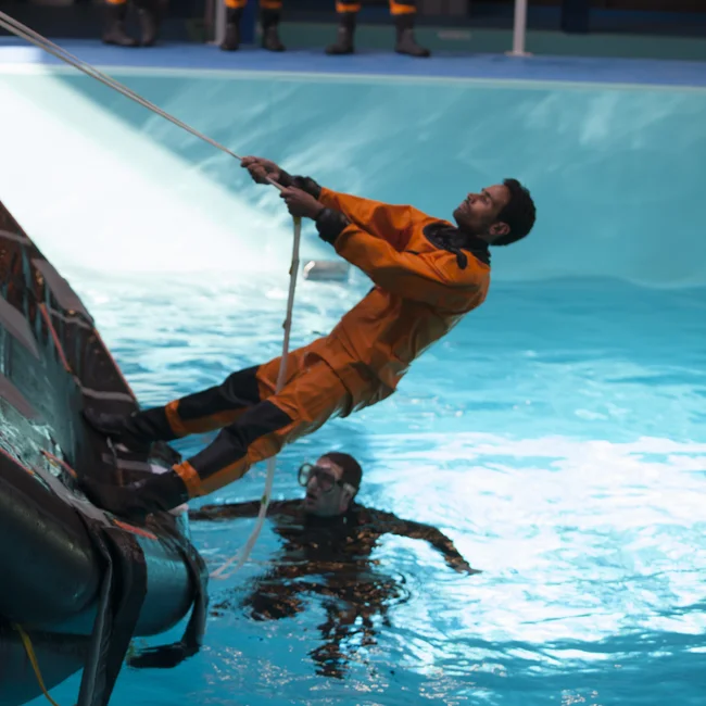 Trainee flipping an inflatable boat in indoor pool